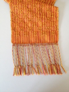 One bead on each group of twisted fringe. Position at lower edge of scarf. 